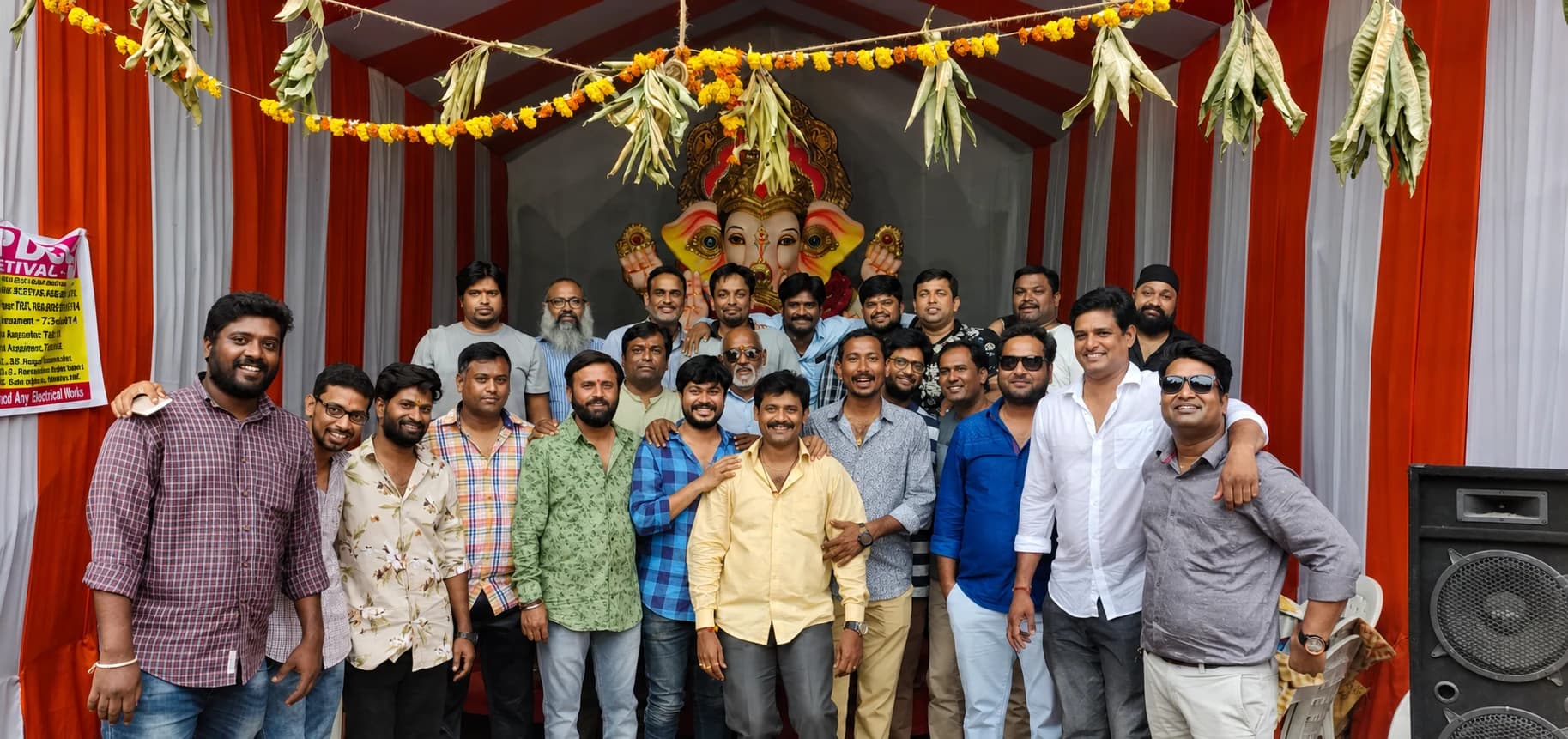 Friends gathered before a Ganesh idol beneath marigold and leaf garlands
